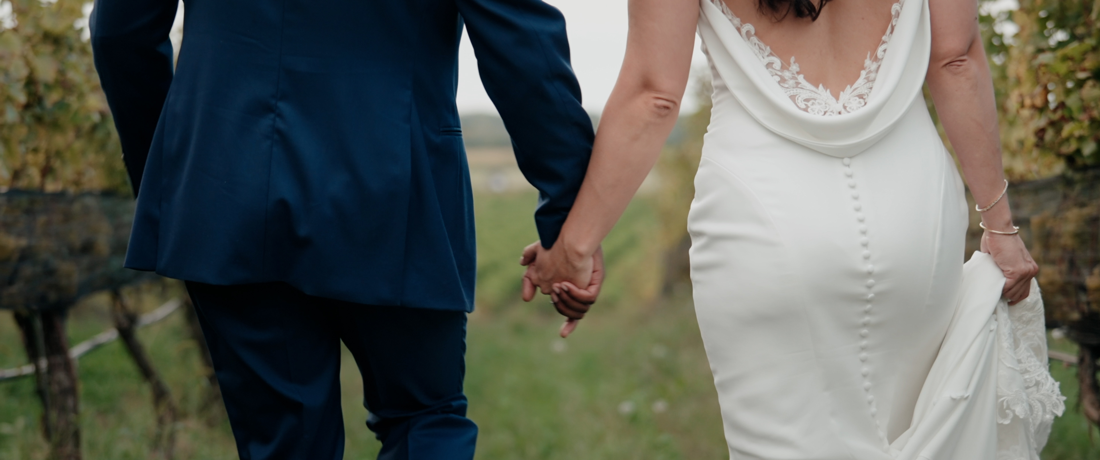 Couple walking through vineyard